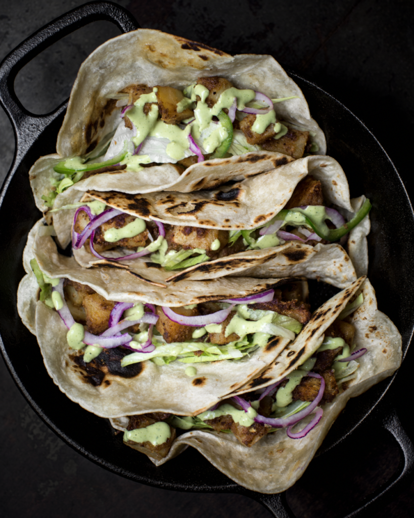 These crispy potato tacos have fluffy, moist chunks of russet potatoes. Baked until crispy, wrapped in a warm tortilla blanket with loads of refreshing goodness.