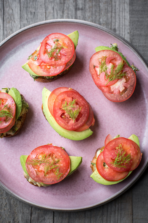 Plate of chickpea avocado salad on sliced bread