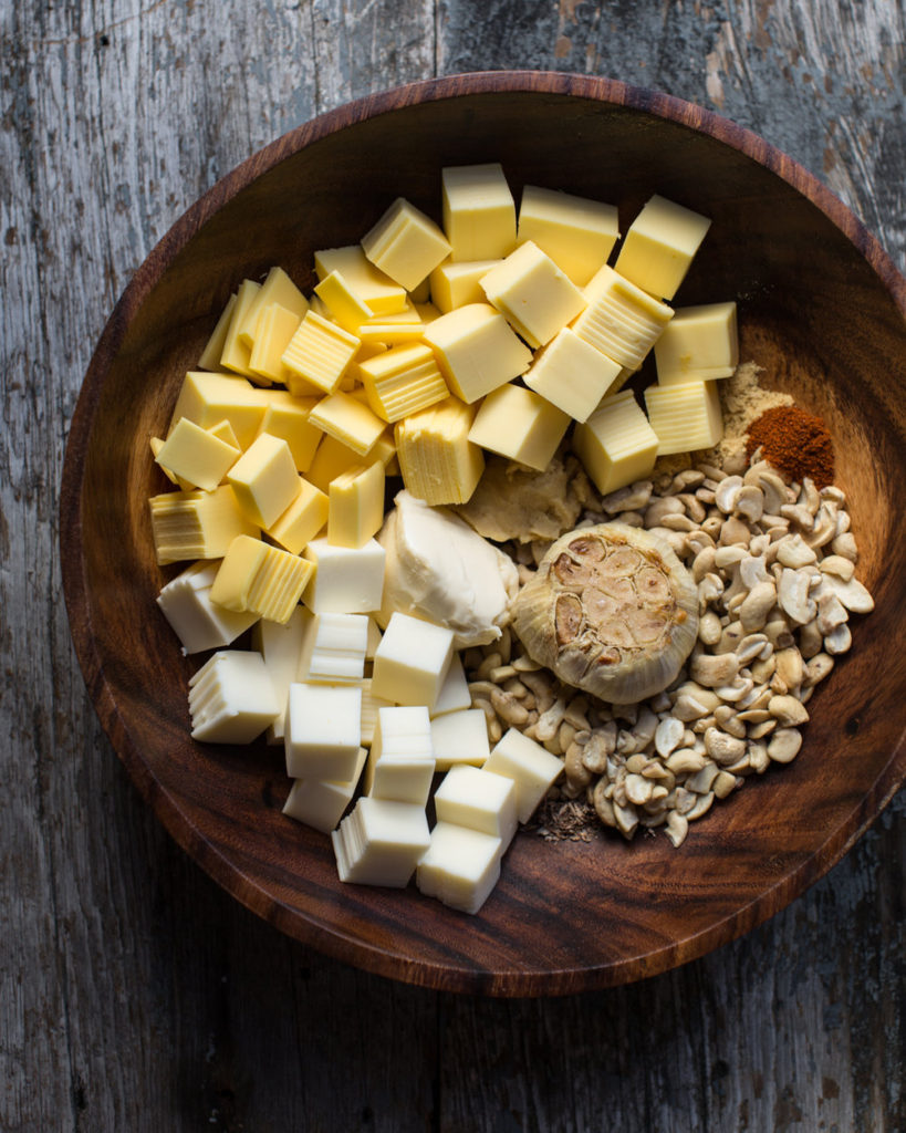 Prepped mac and cheese ingredients in a wooden bowl