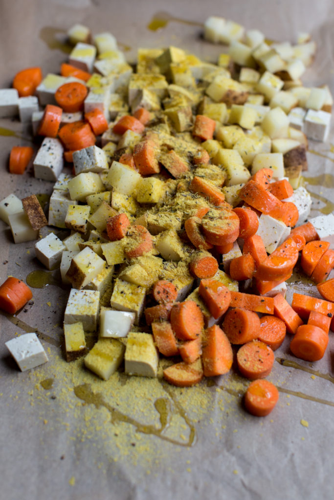 Close up of tofu, carrots, potatoes, and spices.