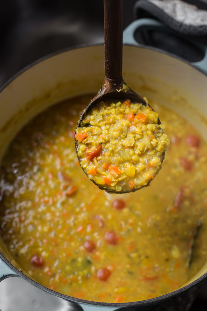 wooden ladle full of vegan dahl