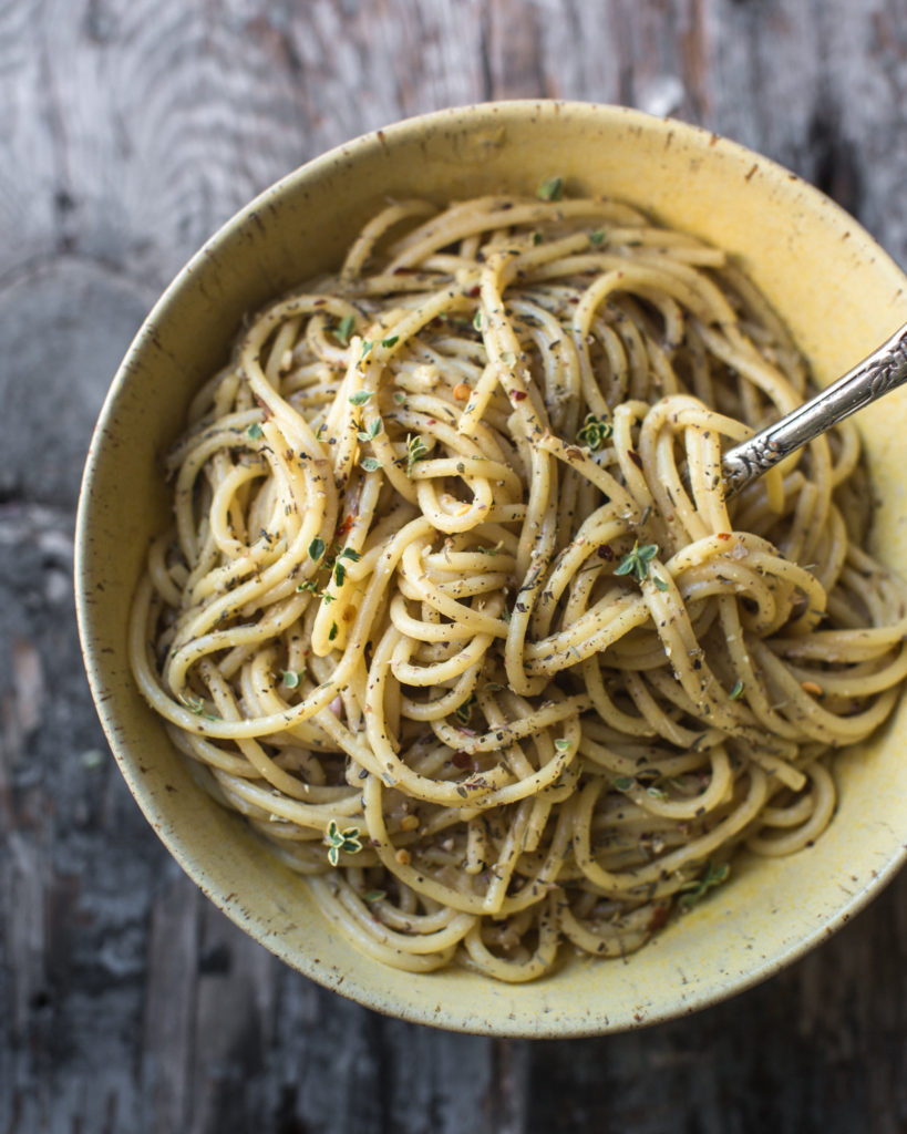 Quick and dirty pasta in a yellow bowl with a fork in the noodles