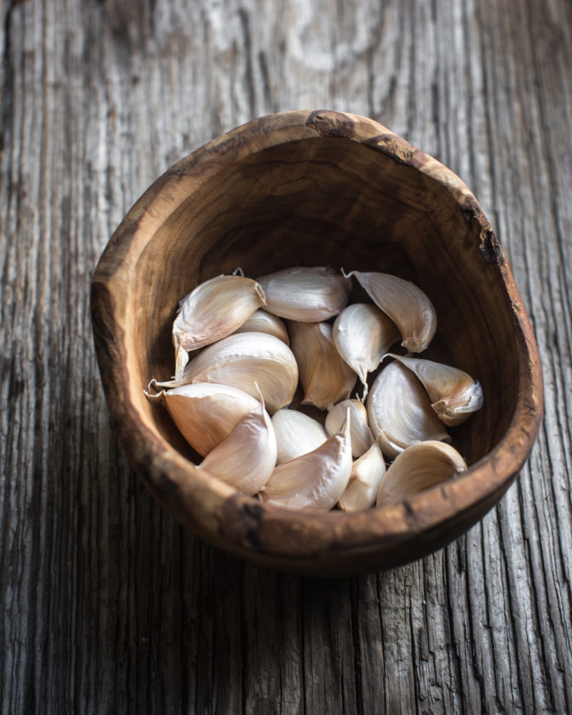 Garlic cloves in a wooden bowl