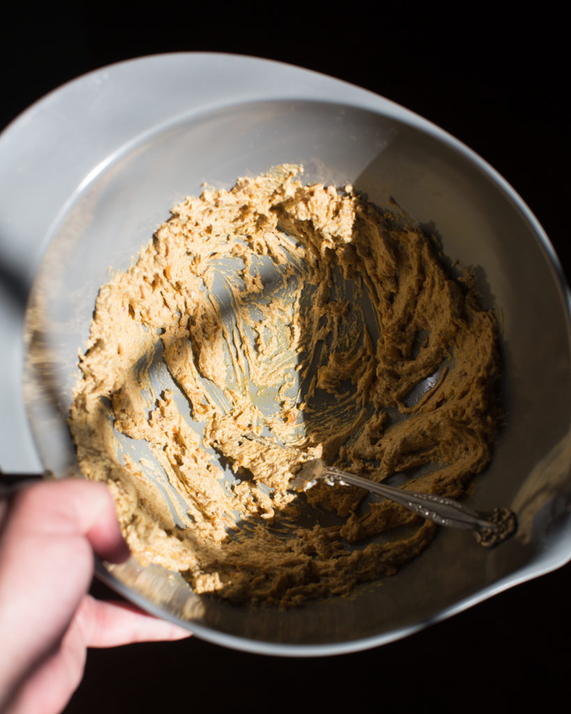 Mashed butter and spices in a large bowl