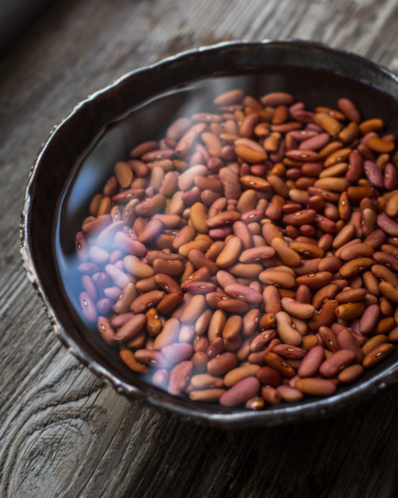 soaking red beans in a black bowl