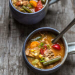 brunswick stew in a serving cup with a spoon