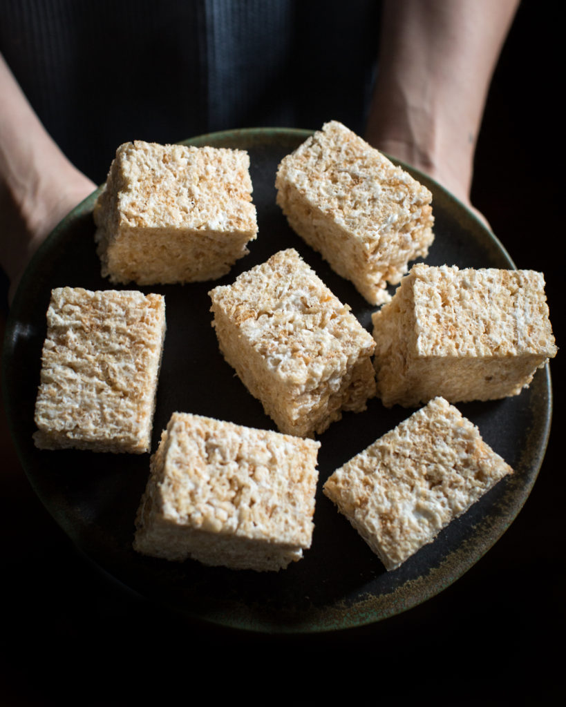 Rice krispie treats on a dark plate