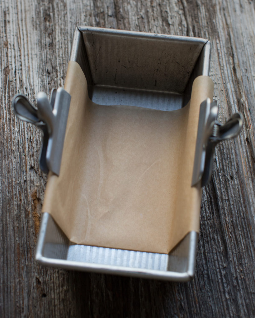 Empty baking pan lined with parchment paper