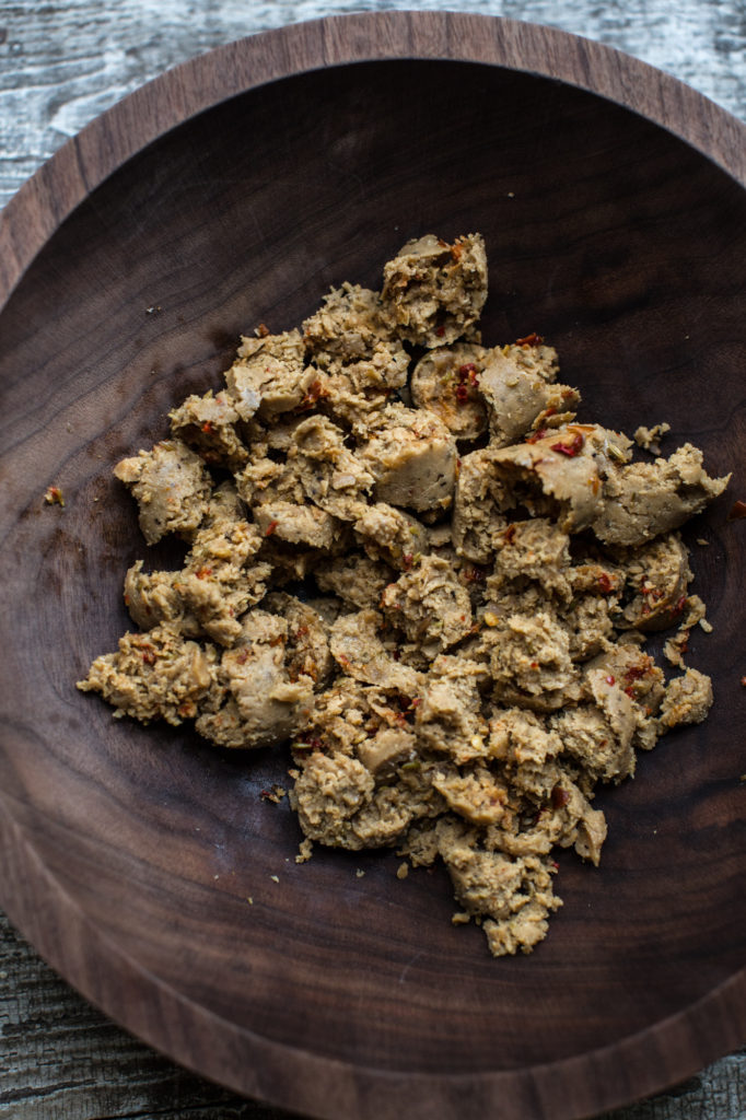 Crumbled plant-based sausage in wooden bowl