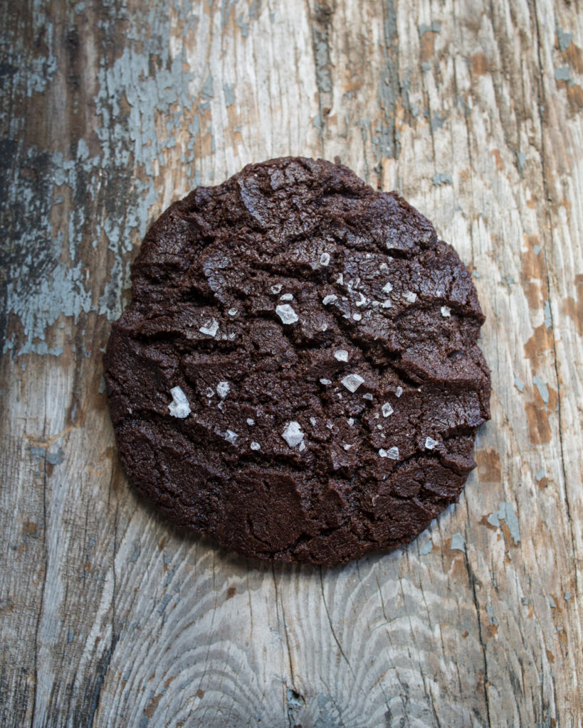 Salted Dark Chocolate Olive Oil Cookie on a wood background
