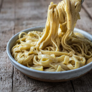 fettuccine alfredo pasta with fork