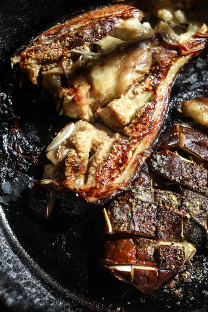 Inside of the garlic roasted eggplant in a skillet