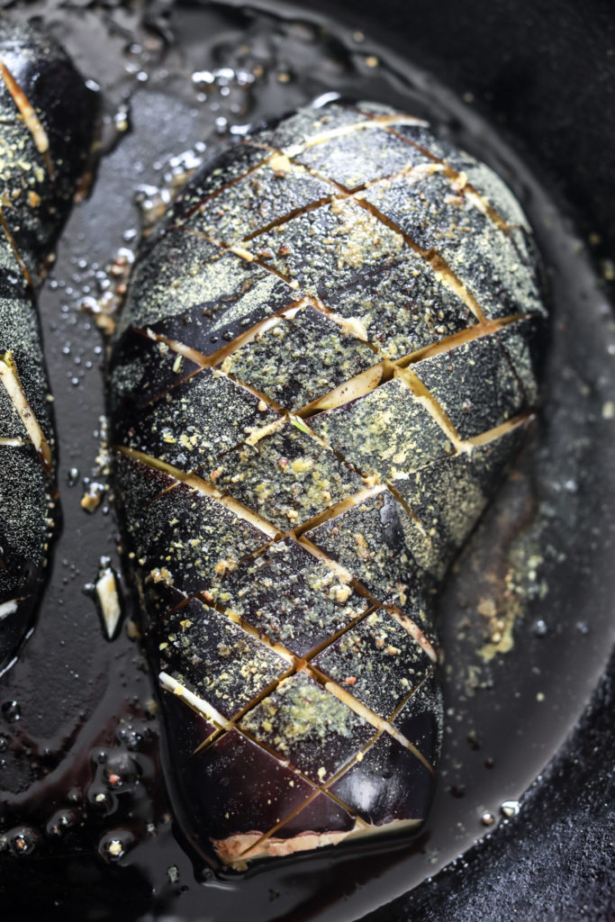 garlic roasted eggplant in a cast iron skillet