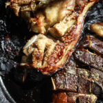 garlic roasted eggplant on a cast iron skillet