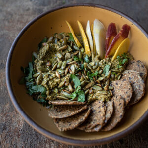 toasted pumpkin seed spread in a bowl with crackers