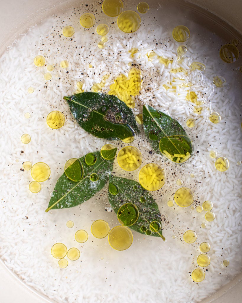 Rice, water, bay leaves and olive oil in a  pot
