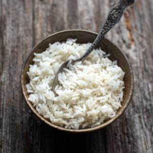 easy baked rice in a serving bowl with a fork