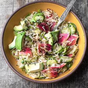 radish and avocado rice in a serving bowl with a fork