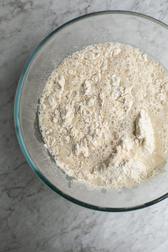 Bowl with wet and dry ingredients for sourdough starter