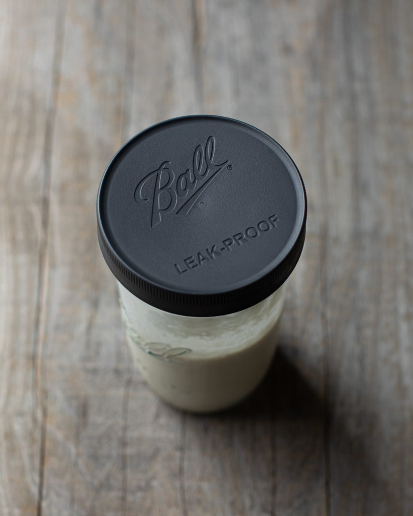 Sourdough starter in a glass jar with a lid