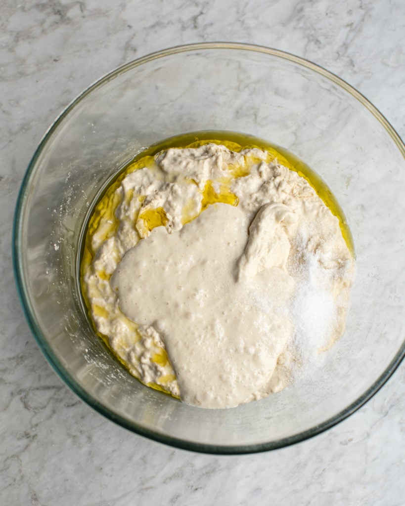 Sourdough starter with olive oil and and salt in a glass bowl