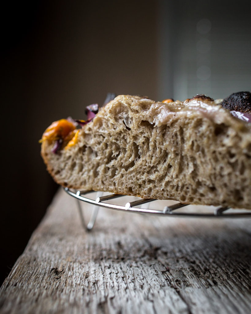 Side view of sourdough cooling on a wire rack