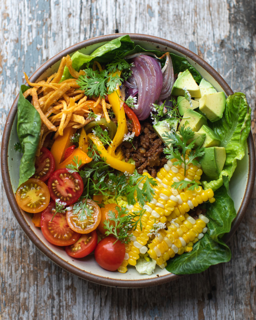 Colorful rainbow taco salad in a bowl
