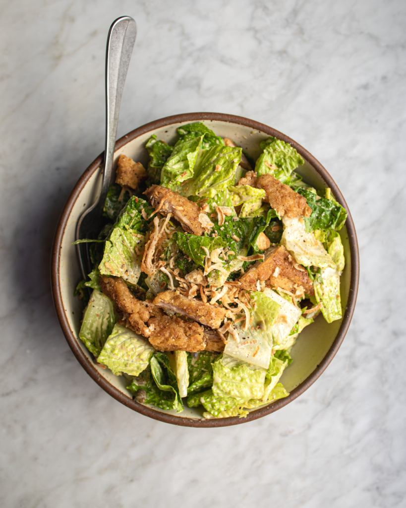 Bowl of crispy chicken caesar salad