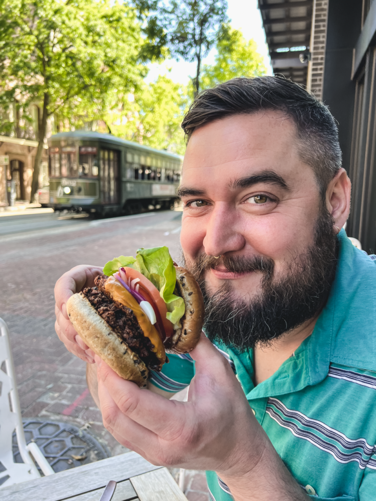 Vegan cheeseburger being held