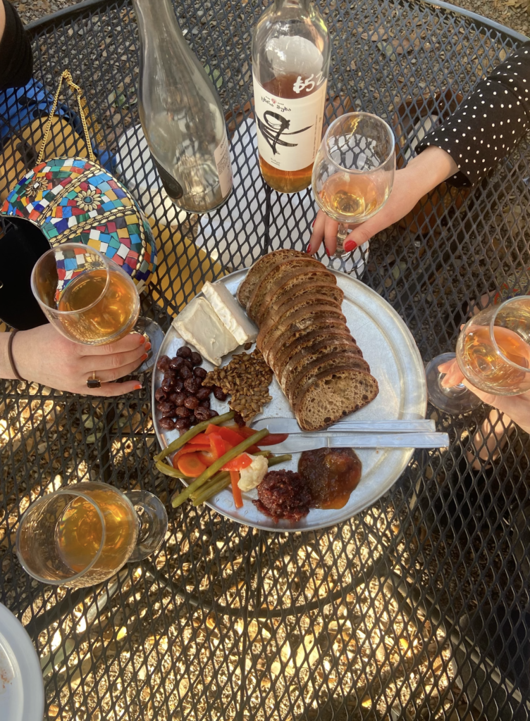 Vegan cheese board with wine glasses 