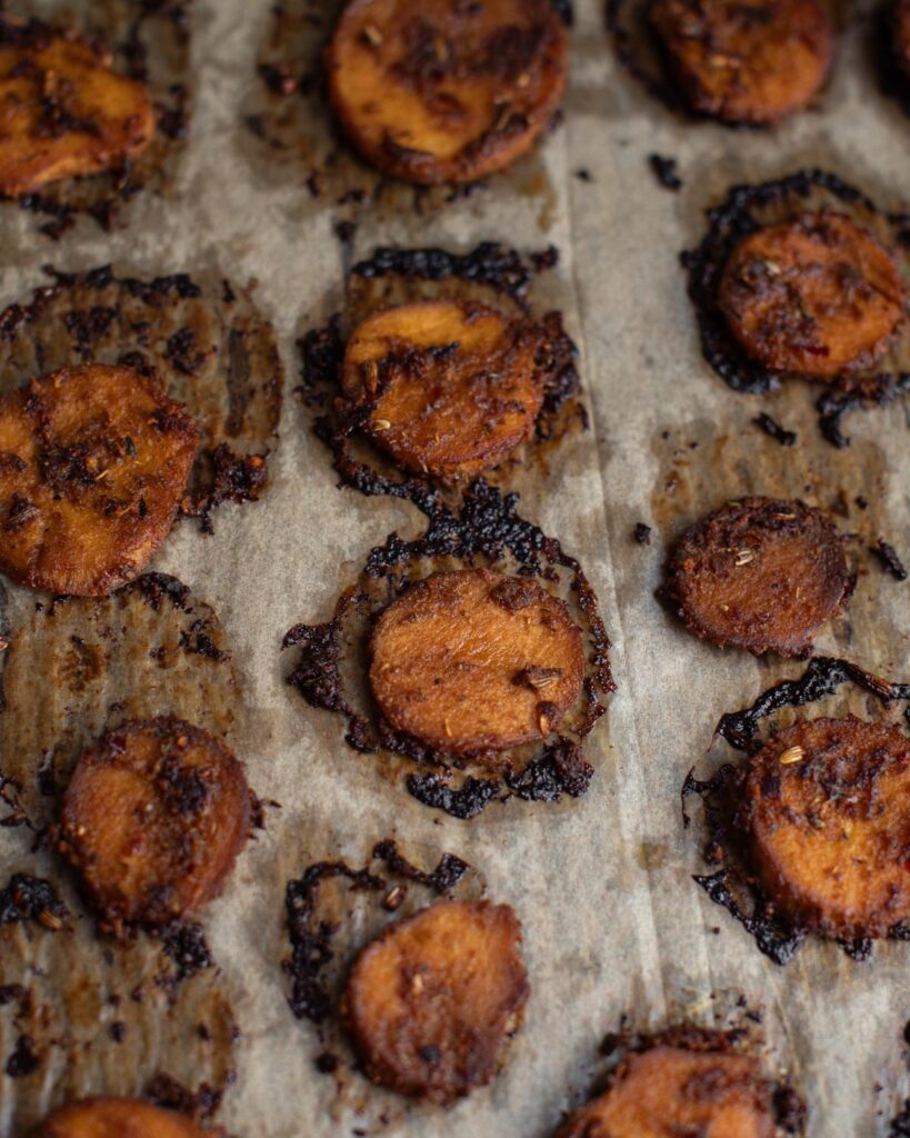 trumpet mushrooms with herbs and spices on a baking sheet