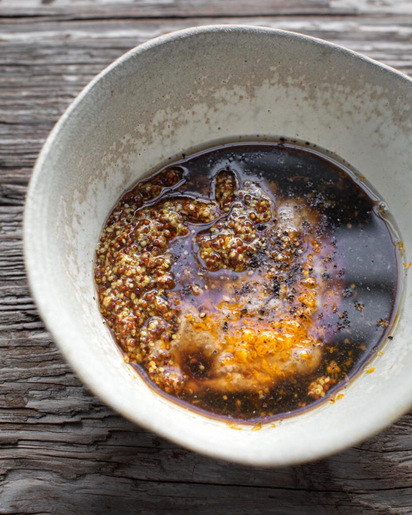 Ingredients for pecan and lemon dressing in a grey bowl