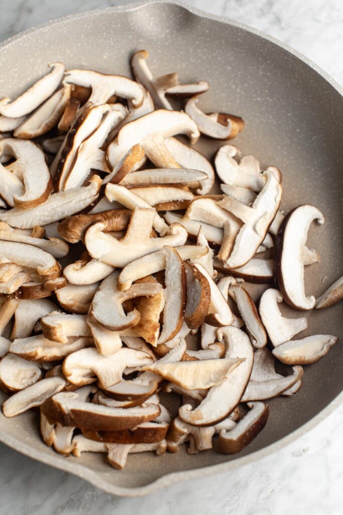 Sliced shiitake mushrooms in a skillet