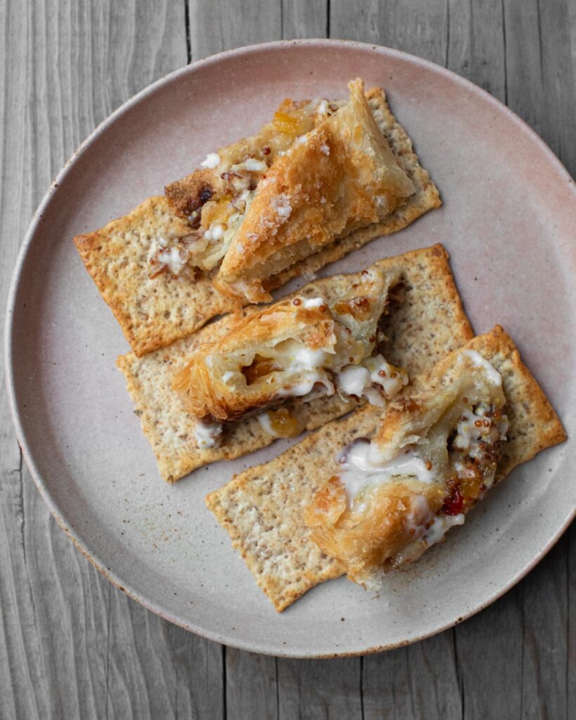 baked vegan feta with pepper jelly on crackers