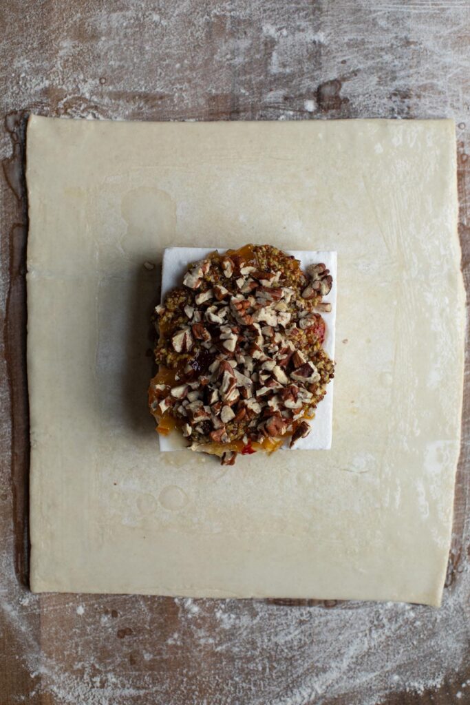 assembling of vegan feta and pepper jelly on dough