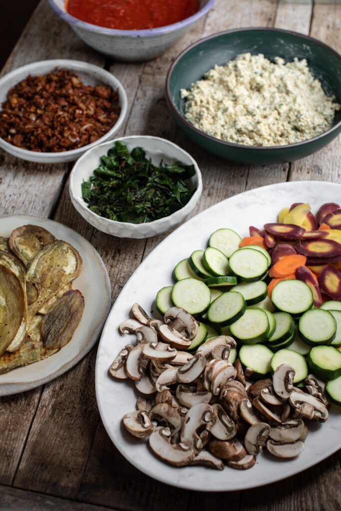 Prepared ingredients on a table for epic lasagna