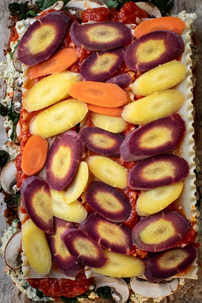 Sliced carrots layer in a baking dish. 