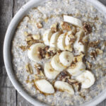 bananas and cream oatmeal in a bowl with toppings