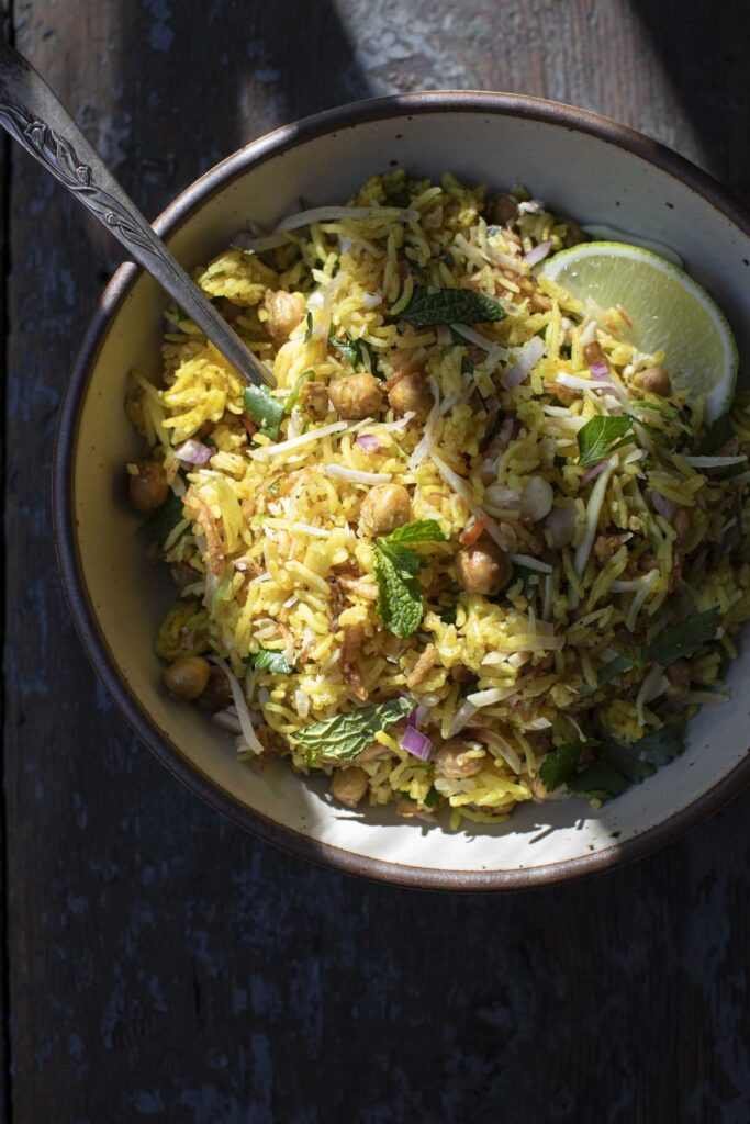 final curried rice salad in a bowl with a spoon