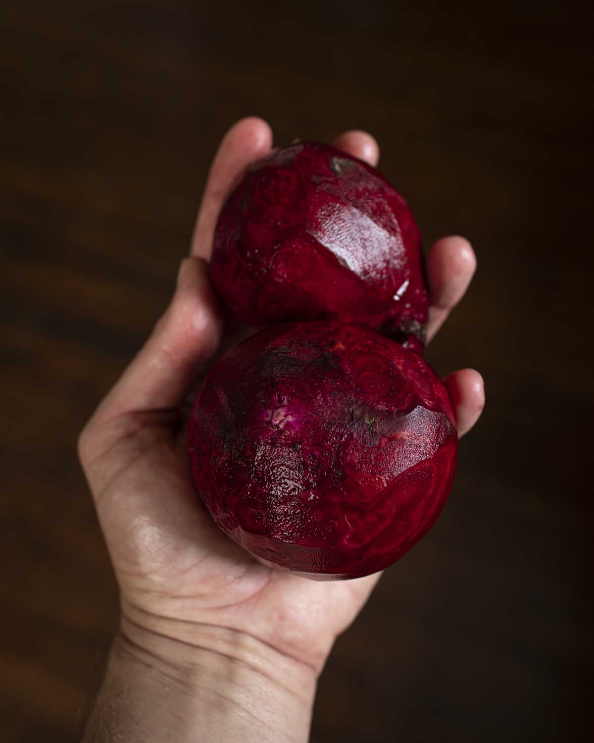 hands holding peeled beets