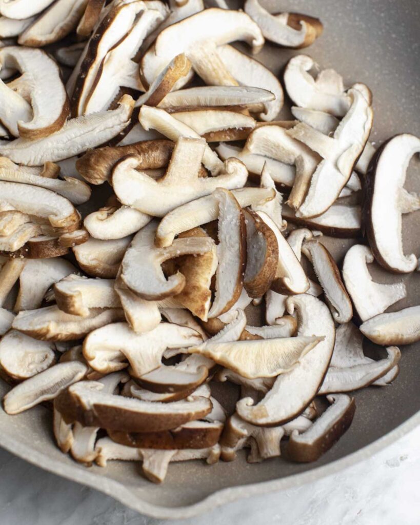 sliced shiitakes in a skillet