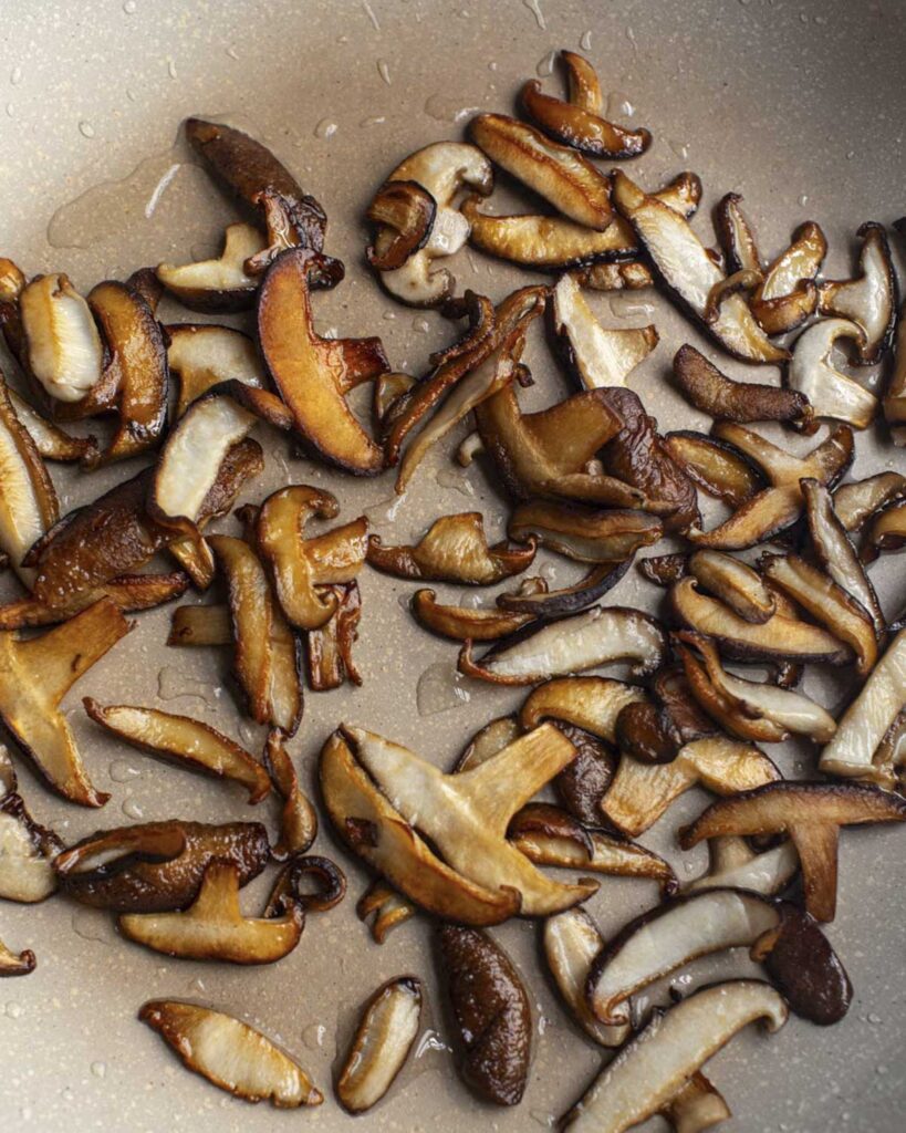 browned shiitake slices in a skillet
