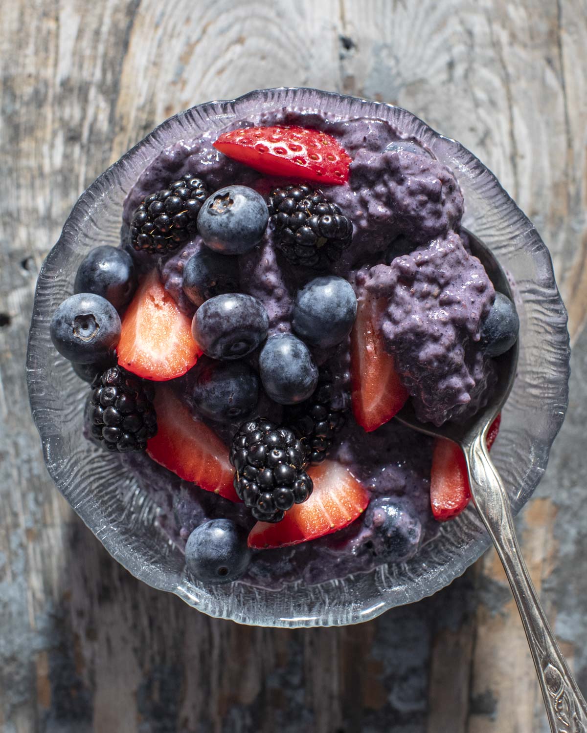 berry chia pudding in a bowl with a spoon