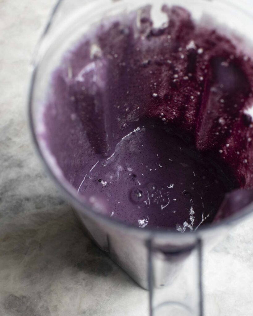 blueberries blended in a blender with soy milk and dates 
