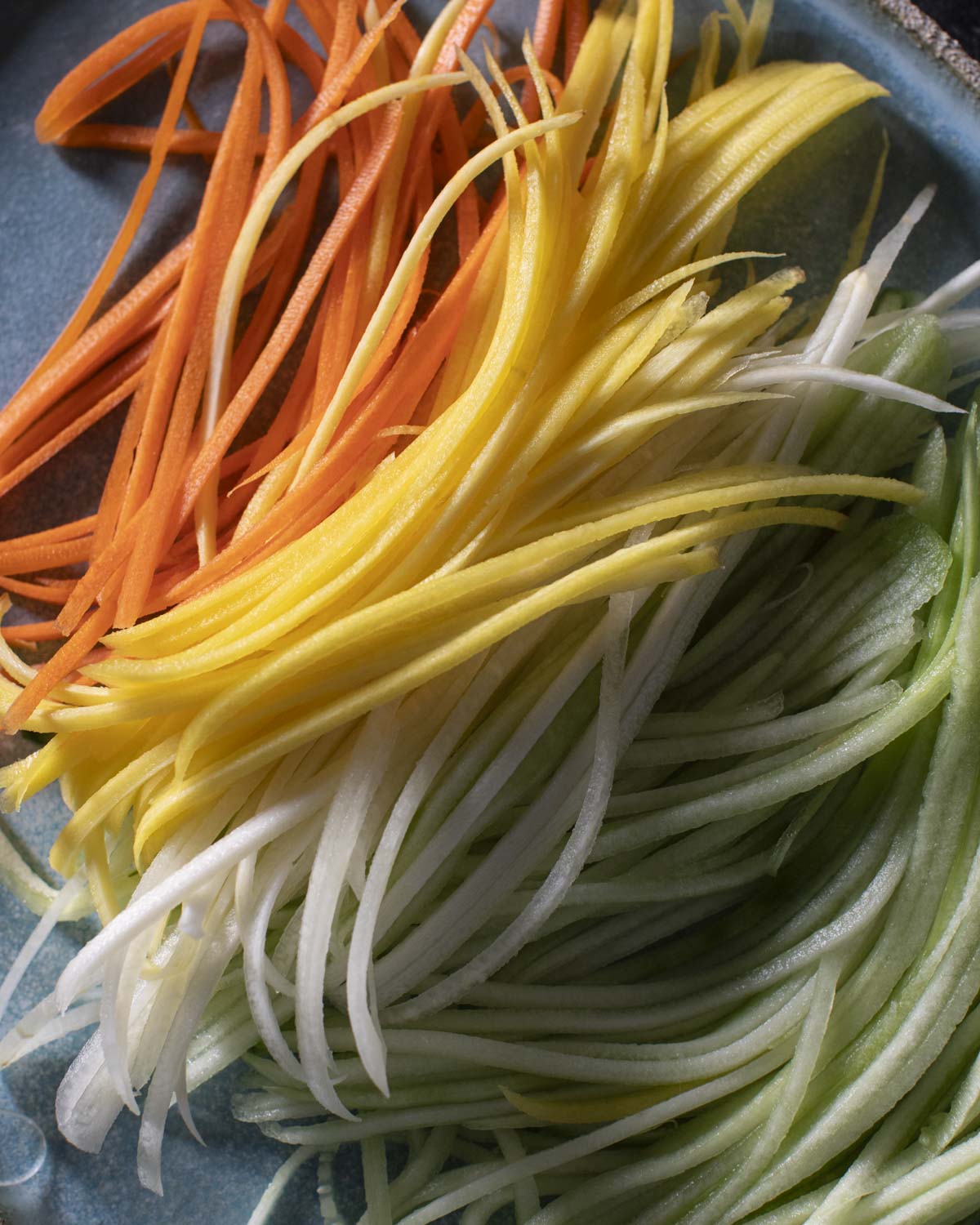 julienned carrots and cucumbers on a plate