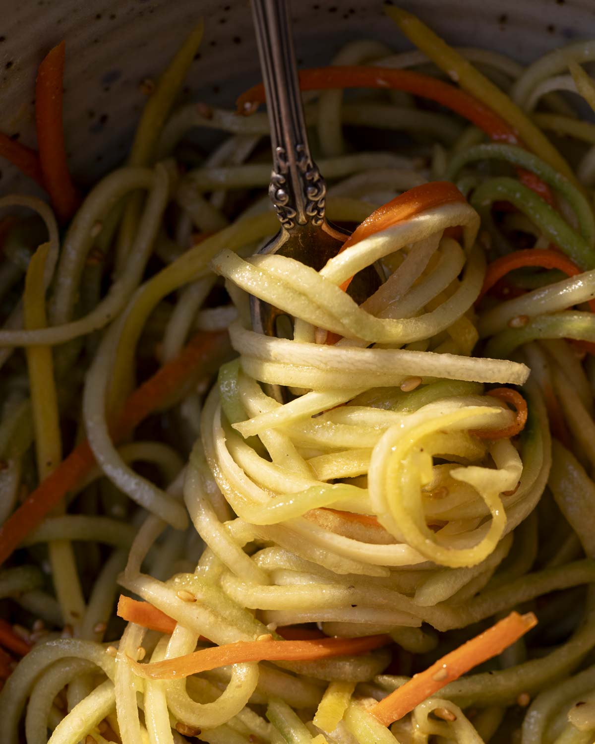 the final cucumber carrot salad on a fork in the sunlight