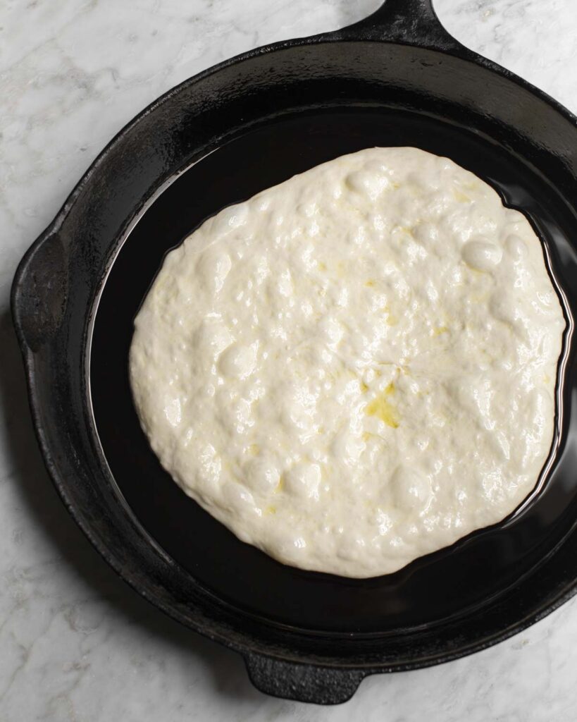 stretched dough in a skillet