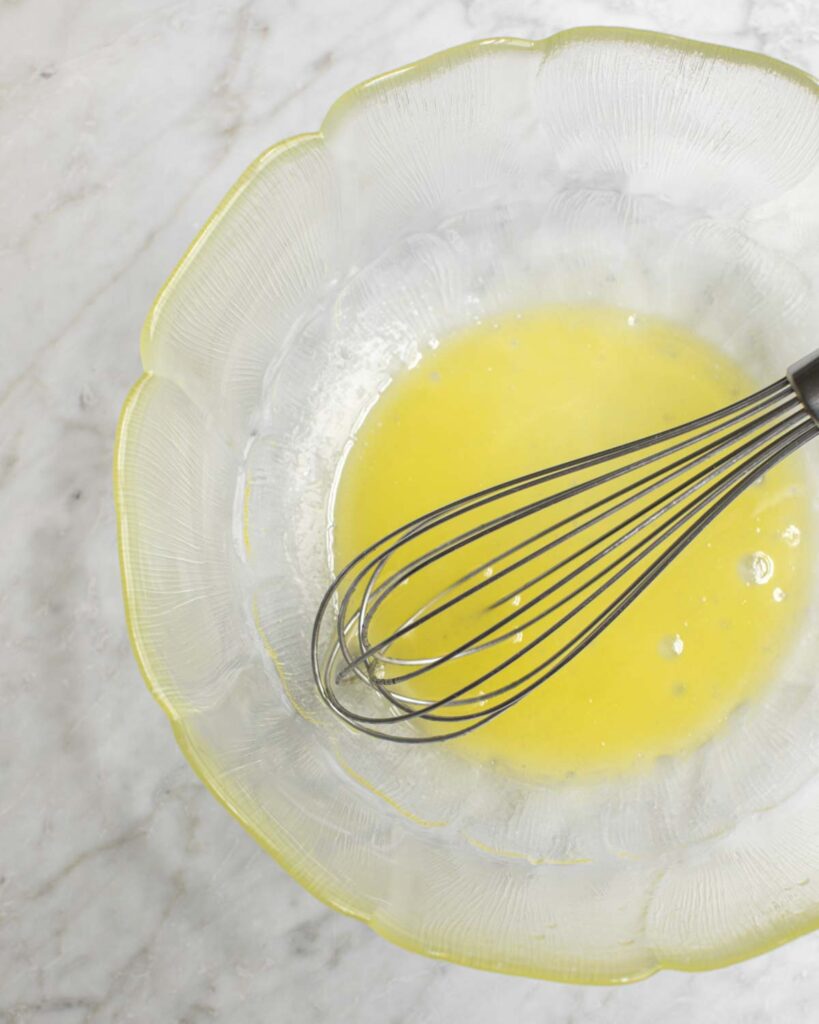 brine ingredients in a bowl with a whisk