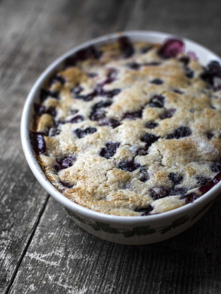vegan blueberry cobbler in a baking dish on a table