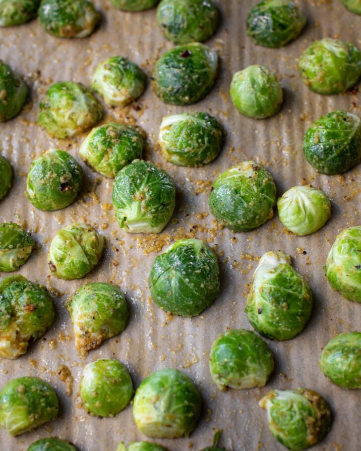 seasoned halved brussels sprouts on a baking sheet facing cut-side down